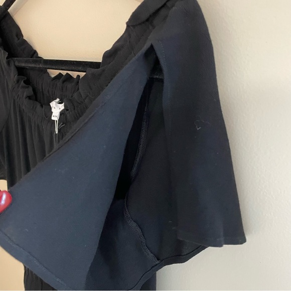 Melissa Nepton black off shoulder jumpsuit with flutter sleeves and tulip legs. - Picture 6 of 9